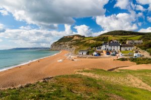 Seatown Beach - picturesque beach set against a verdant hilly background and traditional fishing town in Dorset