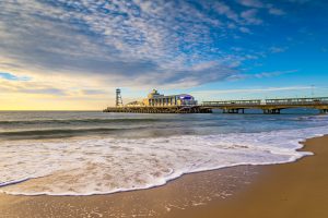 bournemouth beach - eye level photo late evening with light cloud cover and the pier in the distance