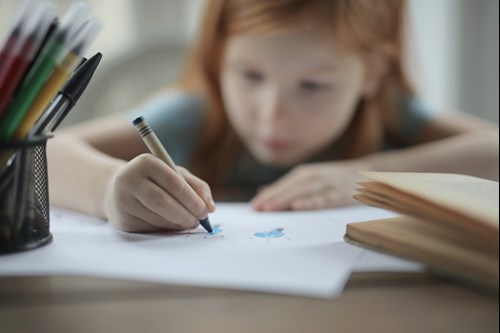 girl holding crayon