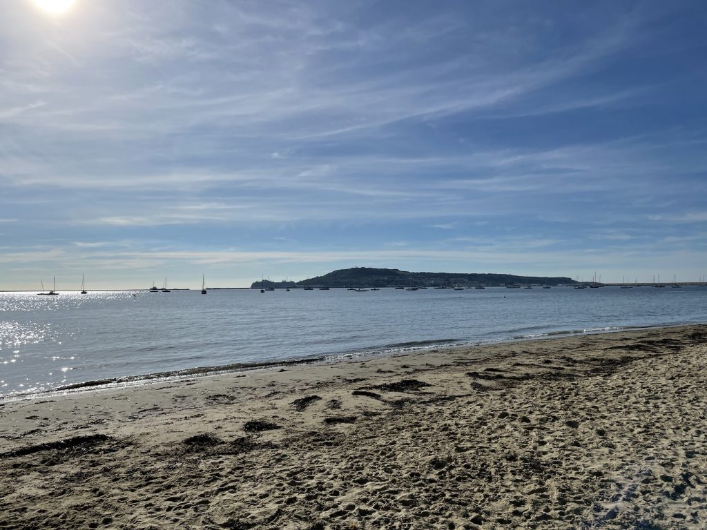 beach with white sand against clear sky backdrop