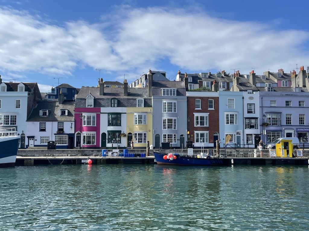 Weymouth town - pastel buildings with sea water in the foreground